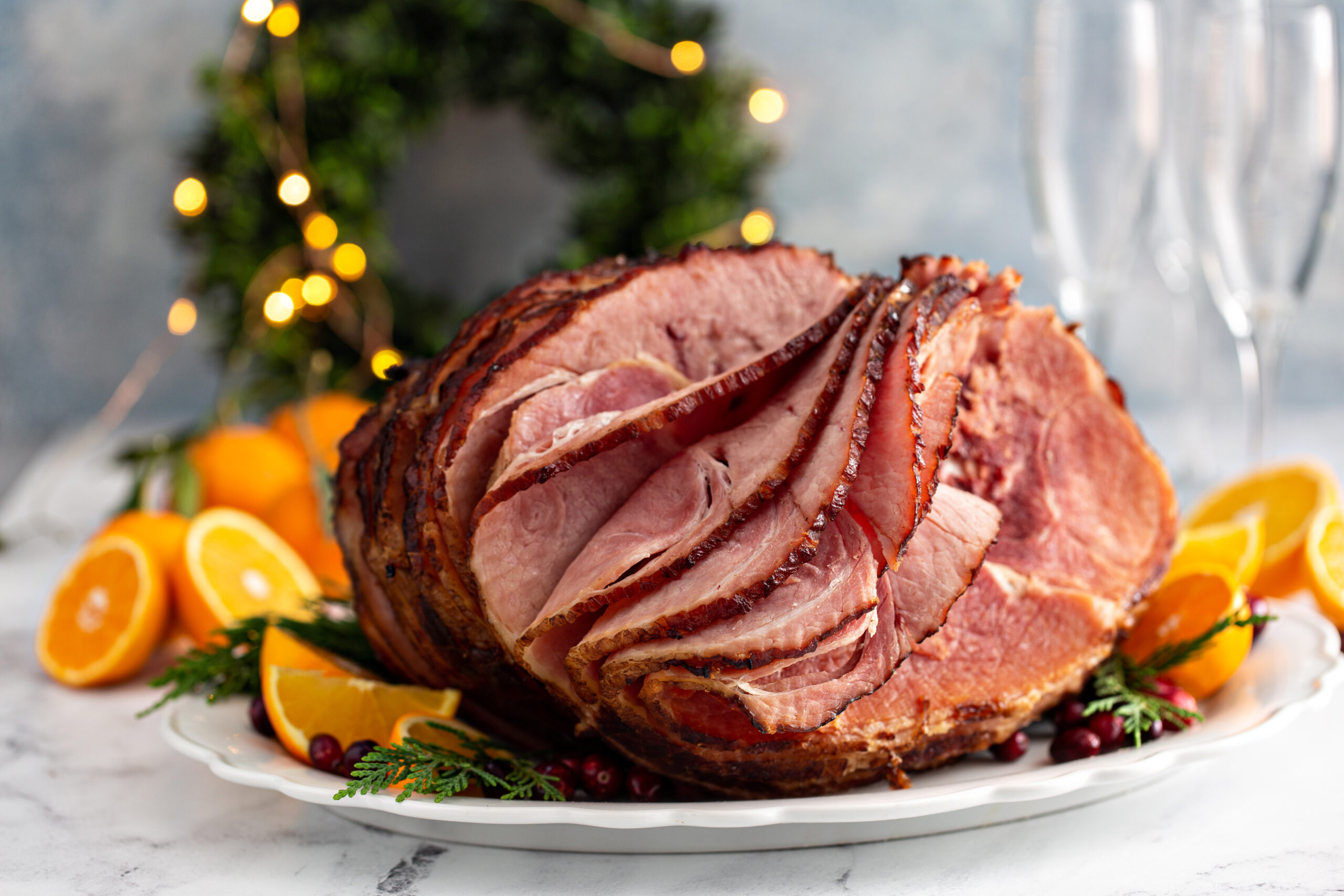 Spiral sliced Christmas ham with orange honey glaze on a serving plate